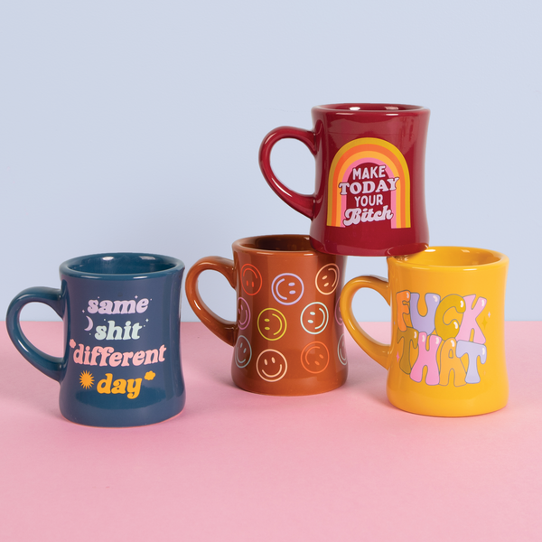 All the feelin' funky diner mugs on a pink surface and a light blue background