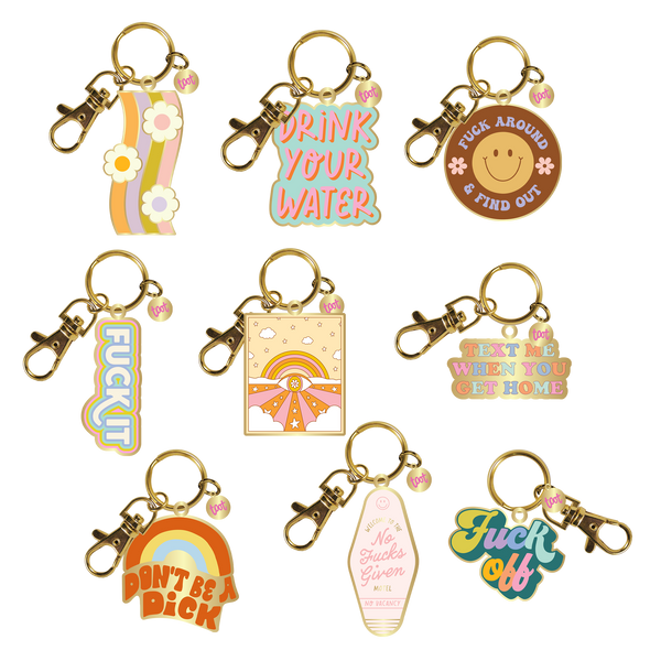 An assortment of 9 Talking Out Of Turn enamel key charms.