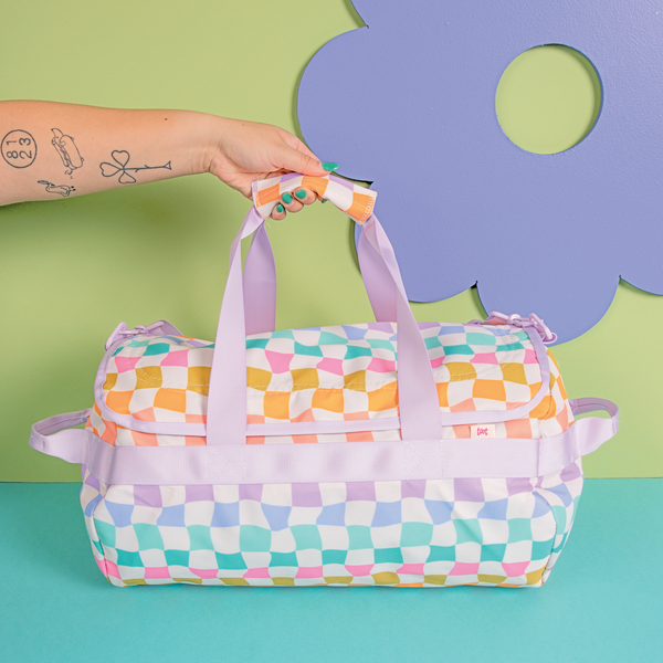 Carnival Checkered Traveler Duffle bag with a green and blue background with a purple flower.