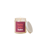 8 oz candle jar with maroon colored label on front with text that reads "holly jolly babe" in red and white letters.