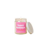 8 oz candle jar with pink label on front with text that reads "happy holidays, bitches" in white and red letters.