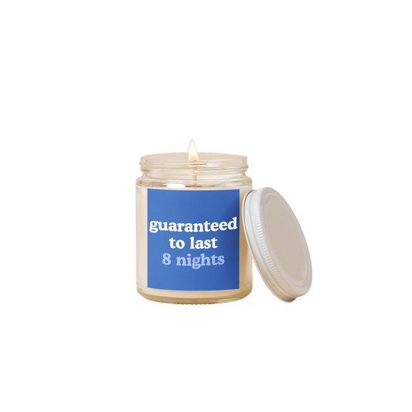 8 oz candle jar with blue label on front with text that reads "guaranteed to last 8 nights" in white and blue letters.