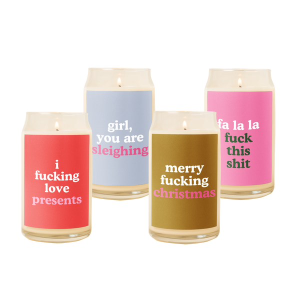 4 different holiday candles with different designs. Red "I fucking love presents", blue "girl, you are sleighing", brown "merry fucking christmas", pink "fa la la fuck this shit"