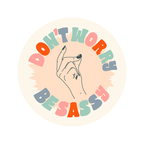 A circle-shaped sticker with a hand snapping their fingers printed on the middle of the sticker. "Don't worry, Be Sassy" printed on the perimeter in multi-colored letters surrounding the snapping fingers.
