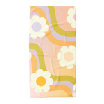 Beach towel with white daisies and a wavy groovy pattern in the colors orange, green, and purple.