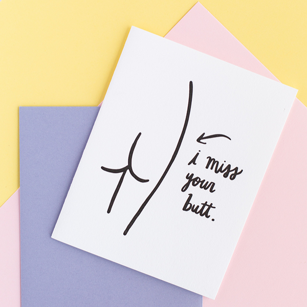 White greeting card with a black outline drawing of a butt. The text says "i miss your butt".