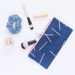Large pencil pouch in navy blue canvas with peach pixie sticks pattern. makeup brushes and beauty products in the bag. -- Midnight - Pixie Sticks