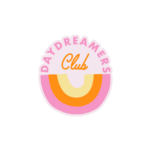 "Daydreaming Club" sticker with a upside down rainbow in the colors pink, orange, and yellow.