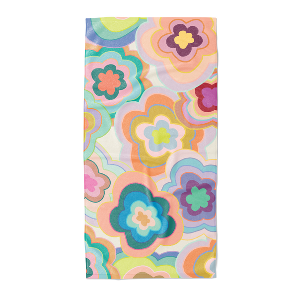 Trippy flower pattern beach towel with an array of colors.