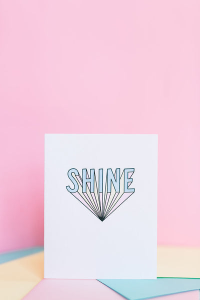 Shine card features a bold graphic of lettering with a pink background.