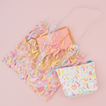 Party Animal Tweedle Dee is a cute cosmetics bag with rainbow confetti pattern and blue zipper.