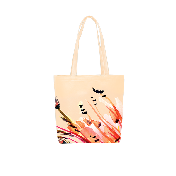 A cute tote bag in peach with large tropical flower print in pink and orange tones. Background color is a light orange-yellow