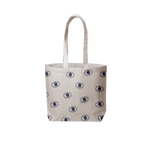 a grey canvas tote bag with blue eyeballs