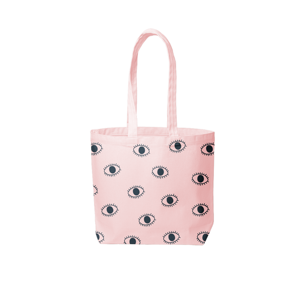 A pink canvas tote bag with blue eyeballs