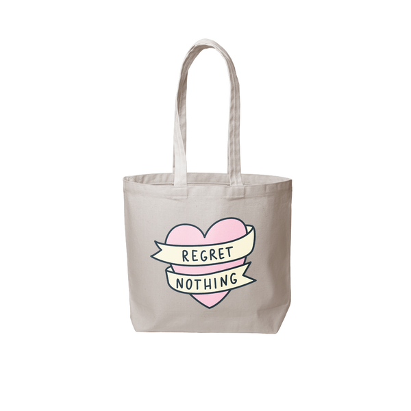 Grey canvas tote bag that has a pink heart and says regret nothing