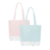 Two cute tote bags; One blue and one pink, with a long shoulder strap and white paint splatter detail along the bottom. 