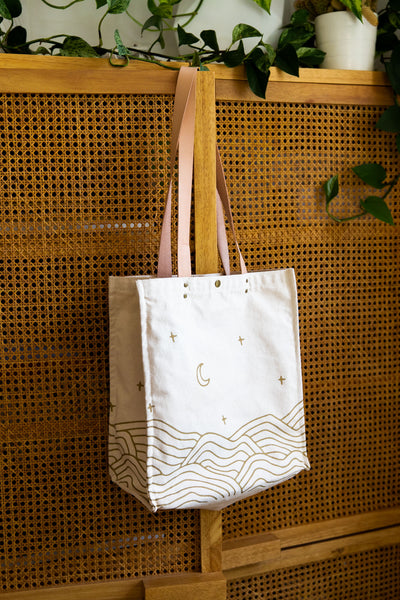 All That Grocery tote with leather handles. Chill hills pattern in metallic gold on all sides of the bag. 