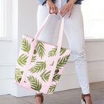 Girl in white jeans holding a cute tote bag in blush pink with leaf pattern.