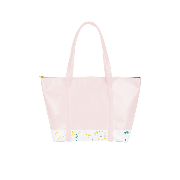a pink vegan leather bag with splatter on the bottom