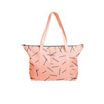 Cute tote bag in peach canvas with navy pixie sticks pattern and navy zipper.