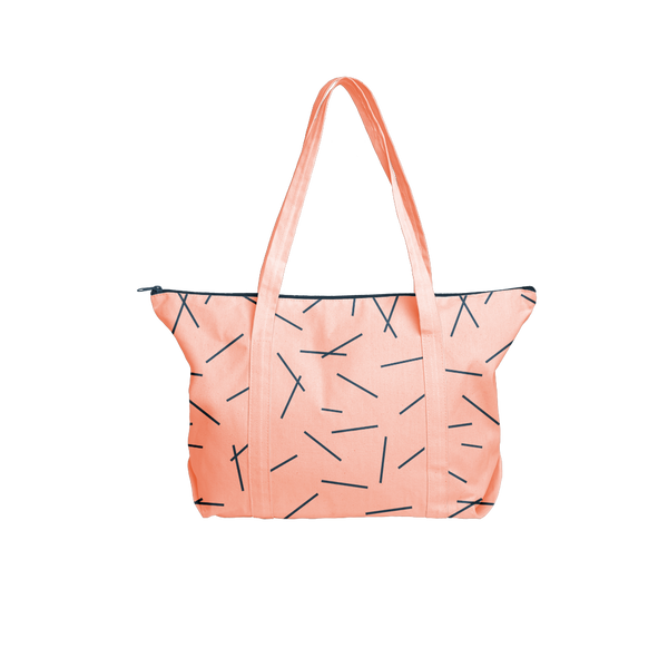 Cute tote bag in peach canvas with navy pixie sticks pattern and navy zipper.