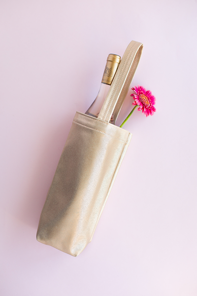 Metallic tote with wine bottle and flower sticking out