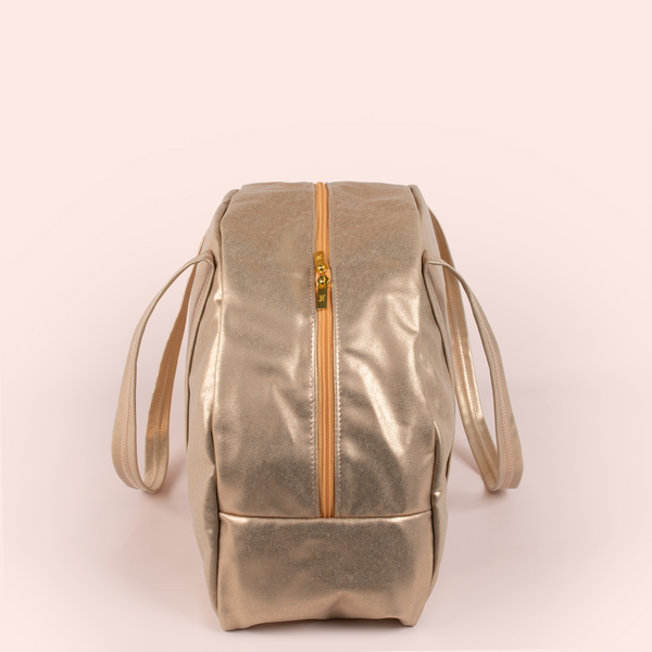 Side view of a cute metallic gold large vegan leather zippered bag.
