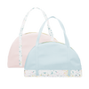 Two travel tote bags, one powder blue with white paint splatter detail along the bottom and one blush pink with white paint splatter straps.