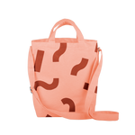 Cute tote bag in peach canvas with adjustable shoulder strap and red macaroni pattern.