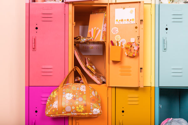 Orange and yellow floral bag hanging from colorful locker