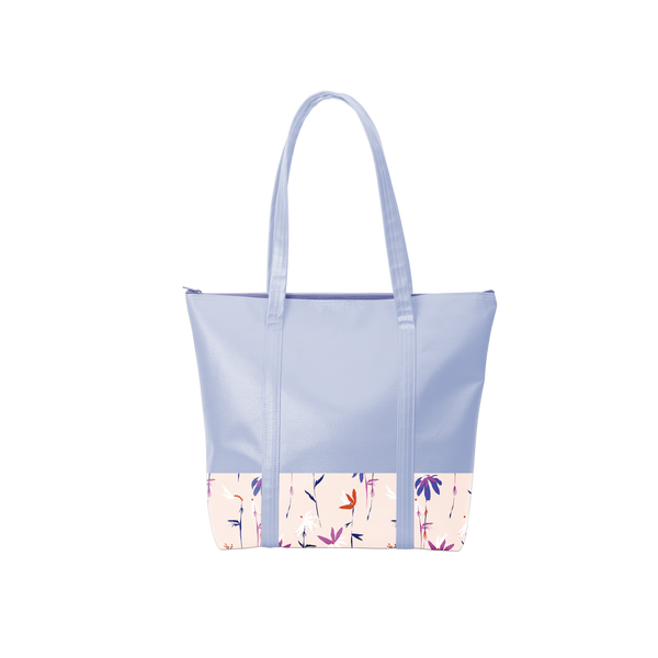 A periwinkle colored tote bag with a floral design on the bottom of the bag in purple, blue, white, and red flowers.