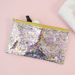 Large pencil pouch in clear vinyl with confetti glitter and a gold zipper.