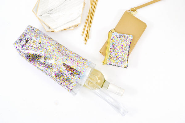 Glitter vinyl wine tote bag with white wine bottle spilling out and a confetti coin purse key ring.