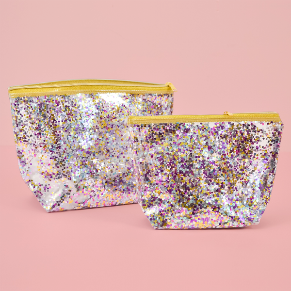 Two cute Cosmetics Bag in a clear vinyl with glitter confetti lining and a gold zippered top.