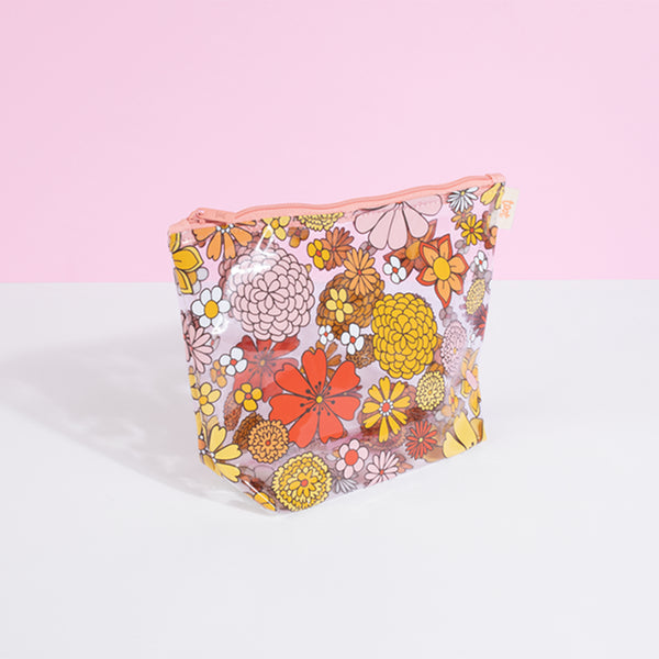 Clear vinyl pouch with floral imprint in amber, gold, pink and peach. Great for cosmetics or small tech. 