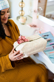 zen ladies doppleganger pouch in tan with a white outline silhouette drawing of a woman's face with blush colored cheeks