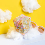 LArge puffy mod pouch with floral pattern resting on a fluffy cloud.