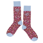 A pair of socks with a multicolored terrazzo design with a cranberry-colored background. Top part of the sock and the toe of the sock is a light blue color and the phrase "Cluster Fuck" is printed above the ankle in the same color blue.