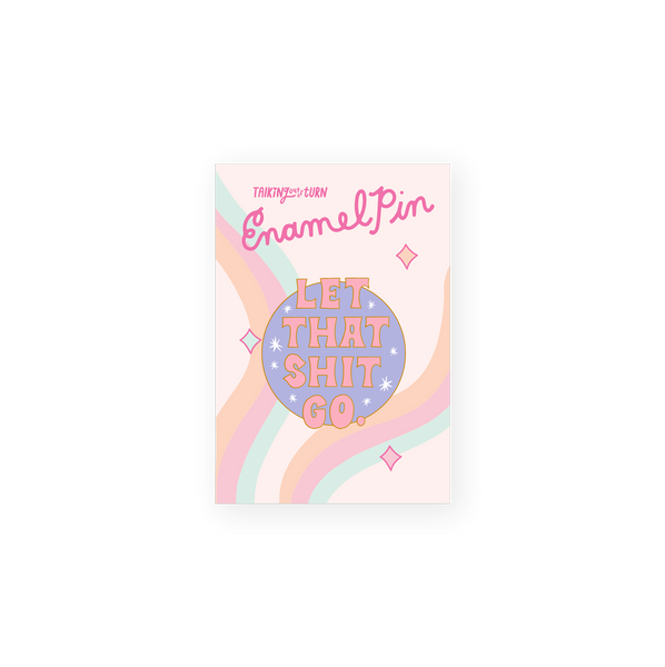 round enamel pin with purple background with saying let that shit go in pink
