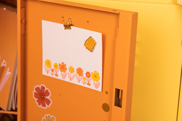 Flower Power Stationery set inside of an orange locker door.