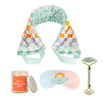 Colorful checkers weighted neck wrap and a "no more mondays" eye pillow with a "you're doing great, babe" orange candle and a face roller.