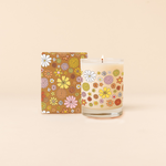 14 oz Rocks glass candle with yellow, orange, pink and white retro floral patterns wraps around candle. Box packaging with same design sits behind candle.