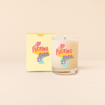 Rocks candle, glass, with multi-color text that says "So Fucking Over It".  Pastel box packing with same multi-color text as candle. 