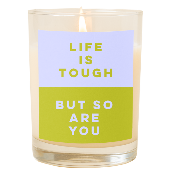 A candle with a decal that says, "Life is tough but so are you." Top half is a a powder blue color and bottom half of decal is an olive green color