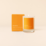 14 oz candle rocks glass with orange decal and text that reads "ANTI-SOCIAL; smells like: I'd rather hang with my dog; with notes of: red cypress + cedar" in white font. Orange box packaging with same design sits behind candle.
