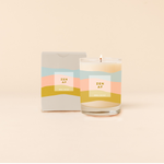 Rocks candle reading "ZEN AF" in front of tri-color horizontal stripes around candle. Box packaging with same design and text as candle.