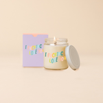 Glass jar candle reading "I FUCKING LOVE YOU" in multi-color text. Box packaging with same text as candle. 