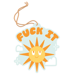 Air freshener with a sky blue background, clouds surrounding the sun, and with "Fuck It" in orange on it.