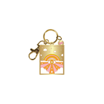 Gold key charm with small white clouds around. Orange, yellow and pink rainbow in the further background. Eye in the center with a white daisy in the middle of the eye. Orange rays with small yellow stars with white clouds in front.