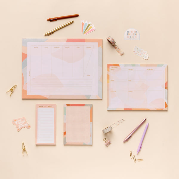 1 extra large weekly desk notepad; 1 large weekly notepad; 1 small notepad; and 1 extra-small notepad. Includes 4 TOOT pens, 4 TOOT stickers, and 2 washi tapes. 